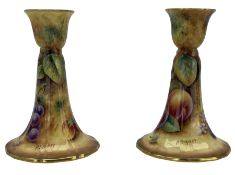 Pair of Royal Worcester candlesticks painted with still life of peaches