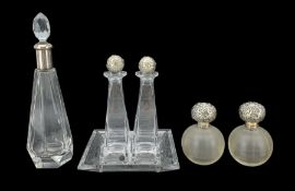 Pair of Edwardian globular ribbed glass scent bottles with silver stoppers