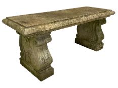 Three-piece weathered cast stone garden bench