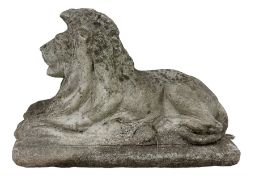 Cast stone garden figure of a recumbent lion on a rectangular plinth
