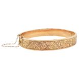 Early 20th century rose gold foliate engraved hinged bangle