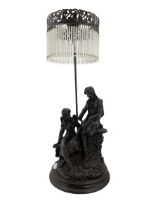 Bronzed resin table lamp with two figures and tasselled shade H75cm