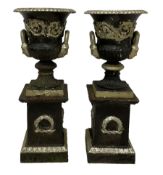 Pair of 20th century cast iron Campana-shaped urns on plinths