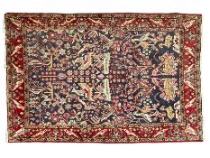Persian indigo and crimson ground rug