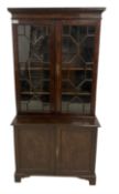 George III figured oak bookcase on cupboard