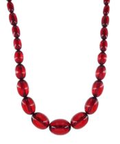 Graduated red bakelite oval bead necklace on a fancy rose cut diamond set clasp stamped 9ct