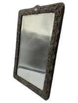Edwardian upright silver table mirror decorated with scrolls and with vacant cartouche and bevelled