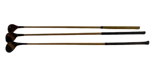 Three hickory shafted golf clubs; one stamped G. Acomb