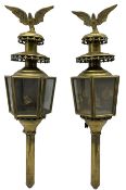 Pair of brass carriage lanterns of hexagonal design with glazed panels and spread eagle finials