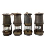 Four steel and brass miners lamps