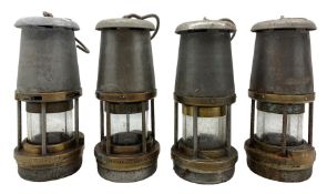 Four steel and brass miners lamps