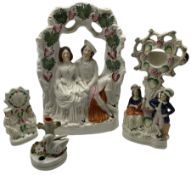 Four pieces of 19th century Staffordshire pottery to include a large flatback depicting newly weds s