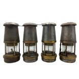 Four steel and brass miners lamps