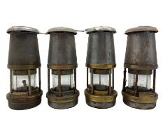Four steel and brass miners lamps