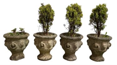 Set of four weathered cast stone urn planters
