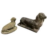 Two weathered cast stone statues of Dachshunds on bases