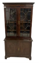 George III figured oak bookcase on cupboard