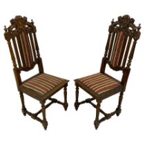 Pair of late Victorian Jacobean Revival heavily carved oak hall chairs