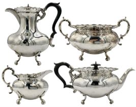 Early 20th century silver four piece tea set of oval design with pierced borders and scroll feet