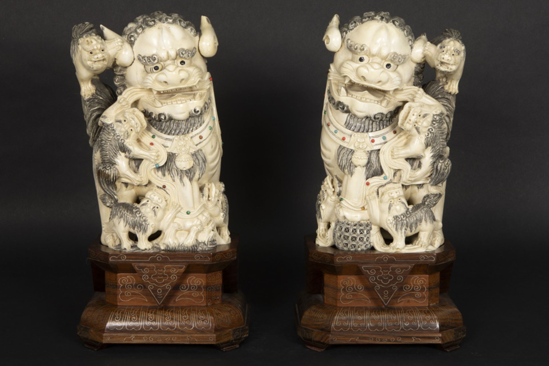 pair of antique Chinese Qing period sculptures in ivory with inlaid cabochons of several kinds of