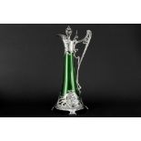 WMF marked Art Nouveau decanter in green glass with a typical mounting with whiplash ornamentation