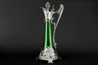WMF marked Art Nouveau decanter in green glass with a typical mounting with whiplash ornamentation
