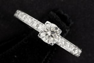 a 0,51 carat quality brilliant cut diamond set in a ring in white gold (18 carat) with ca 0,50 carat