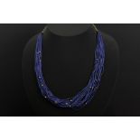 necklace with 20 strings of beads in lapis lazuli and some in gold & with a chain in yellow gold (18