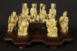 'antique' Chinese group with eight sculptures in ivory standing round a table : "The Eight