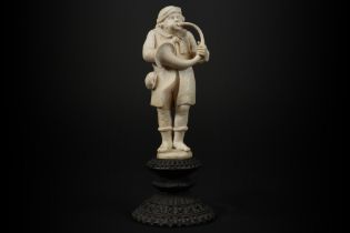 19th Cent. European, presumably German, sculpture in ivory - on an antique base in carved wood -