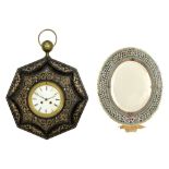 antique wall clock (with marked and dated work) and an oval mirror with its frame in metal and micro