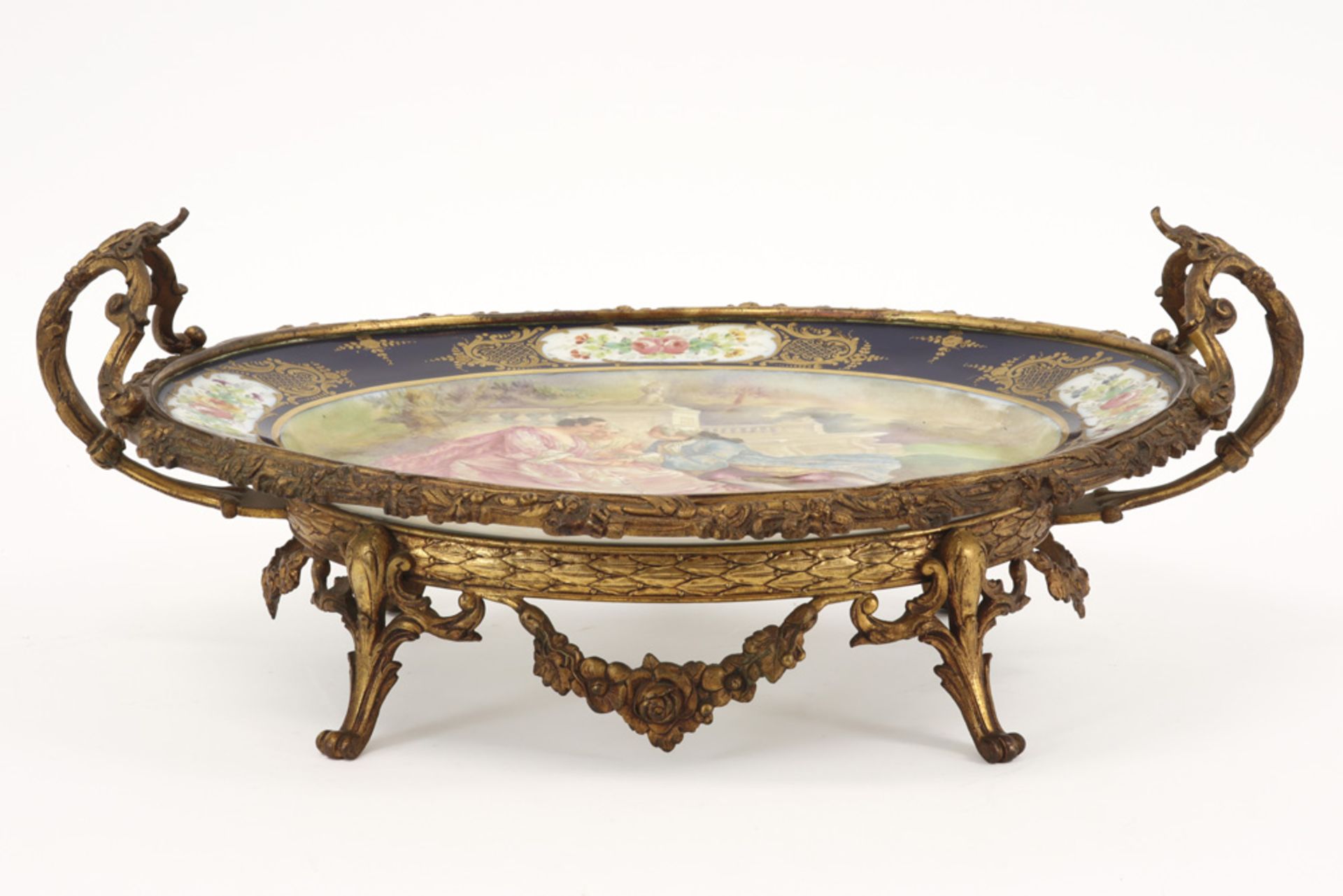 oval dish in Sèvres marked porcelain with paintings, signed Rochette, and with mounting in gilded