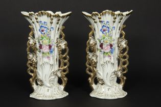pair of vases in porcelain with a painted flower decor || Paar cornetvazen in porselein met een