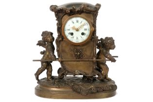 antique clock with a quite special design with a carriage towed by two Cupids - in bronze and with a