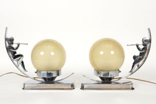 pair of Art Deco lamps with chromed base adorned with a boy sitting on a crescent and with a glass