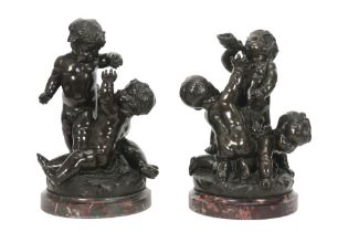 pair of antique bronze sculptures, each with three playing children - each on a base in red