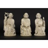 set of three antique Chinese late Qing period sculptures in ivory, each depicting a man with a