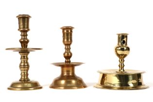 three bronze candlesticks to be dated in the 17th and 18th century || Lot van drie bronzen