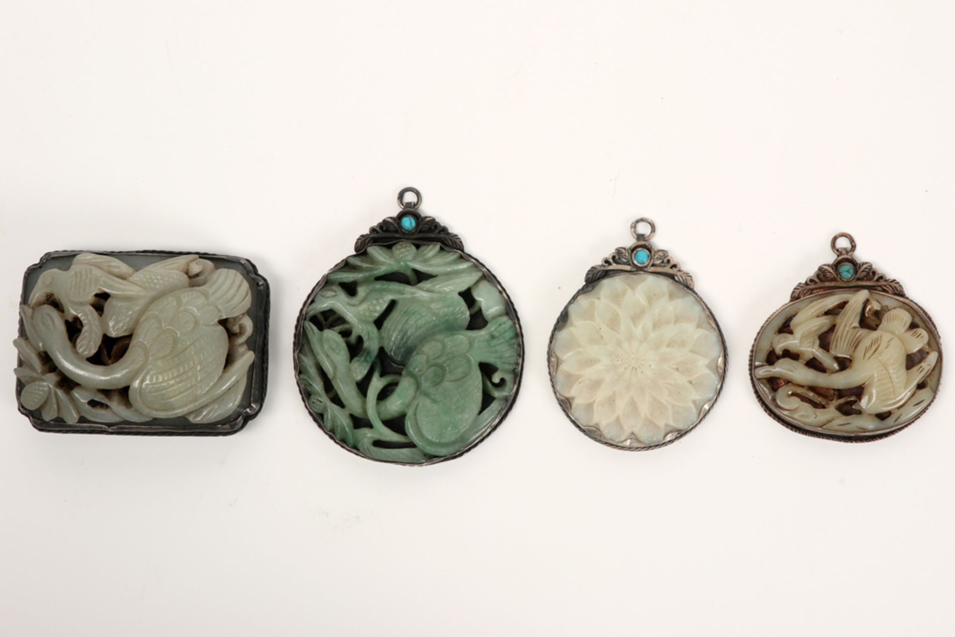 three Chinese pendants and a buckle in marked silver and jade || Lot (4) van drie Chinese