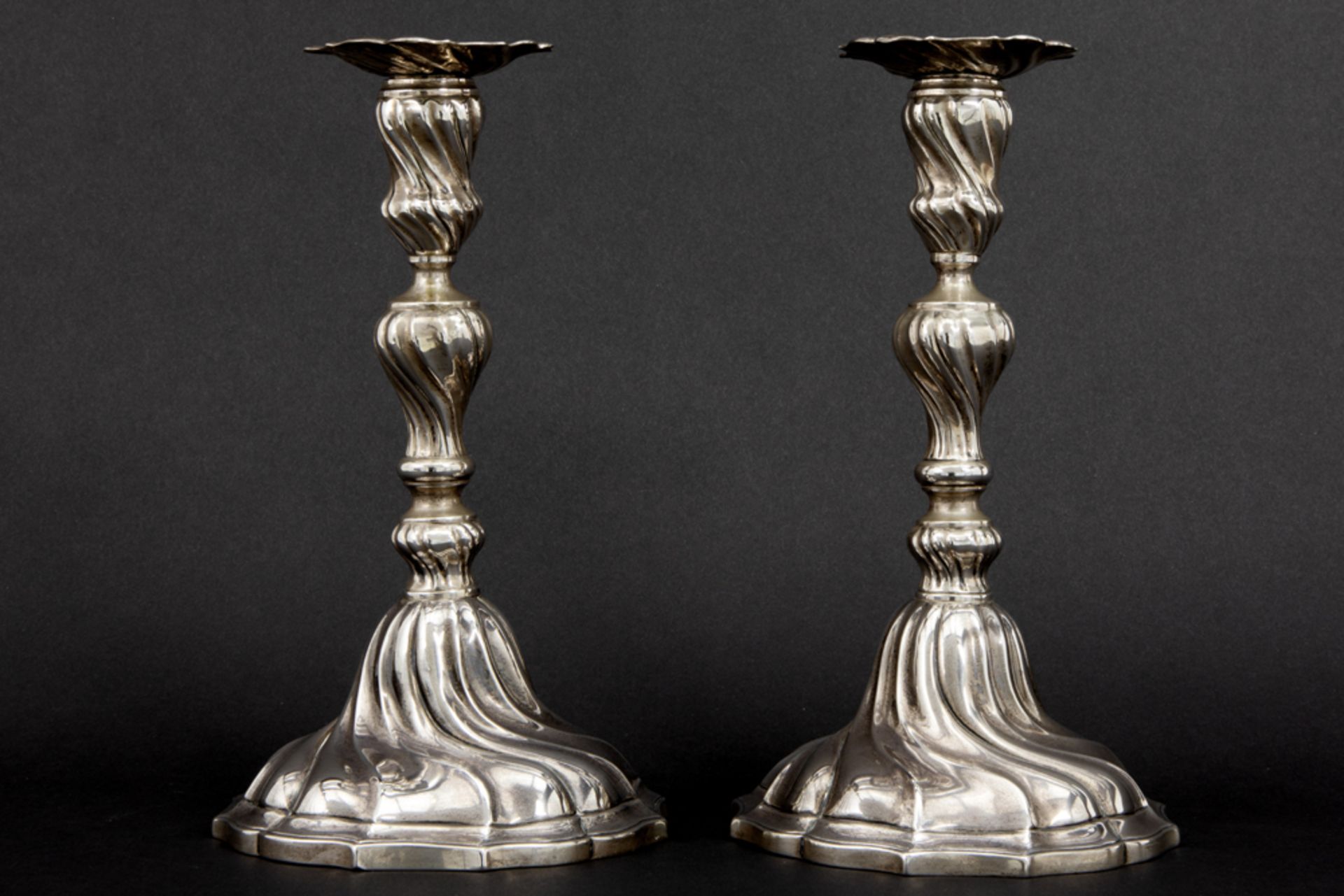 pair of Belgian "Delheid" signed candlesticks in marked silver with a Louis XV style design ||