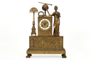 early 19th Cent. Empire style clock with its case in gilded bronze with a lady with all kinds of