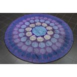 round sixties' rug with a typical design and typical colours (matching the upholstery of the chairs)