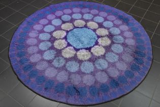 round sixties' rug with a typical design and typical colours (matching the upholstery of the chairs)