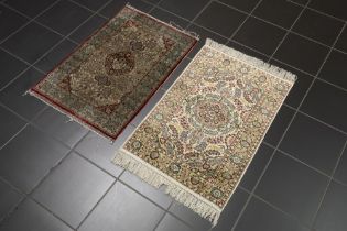 two small hand knotted rugs in silk || Lot van twee kleine handgeknoopte tapijtjes in zijde op zijde