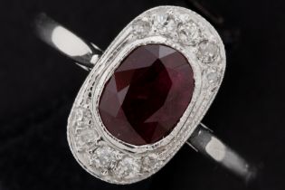 Art Deco ring in grey gold (18 carat) with a circa 2,20 carat, oval Siamese ruby and circa 0,25