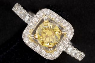 a 0,62 carat high quality natural fancy vivid orange yellow brilliant cut diamond set in a ring in