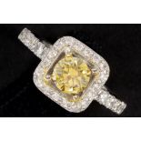 a 0,62 carat high quality natural fancy vivid orange yellow brilliant cut diamond set in a ring in