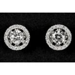 pair of earrings in white gold (18 carat) each with a bigger diamond surrounded by small ones - in