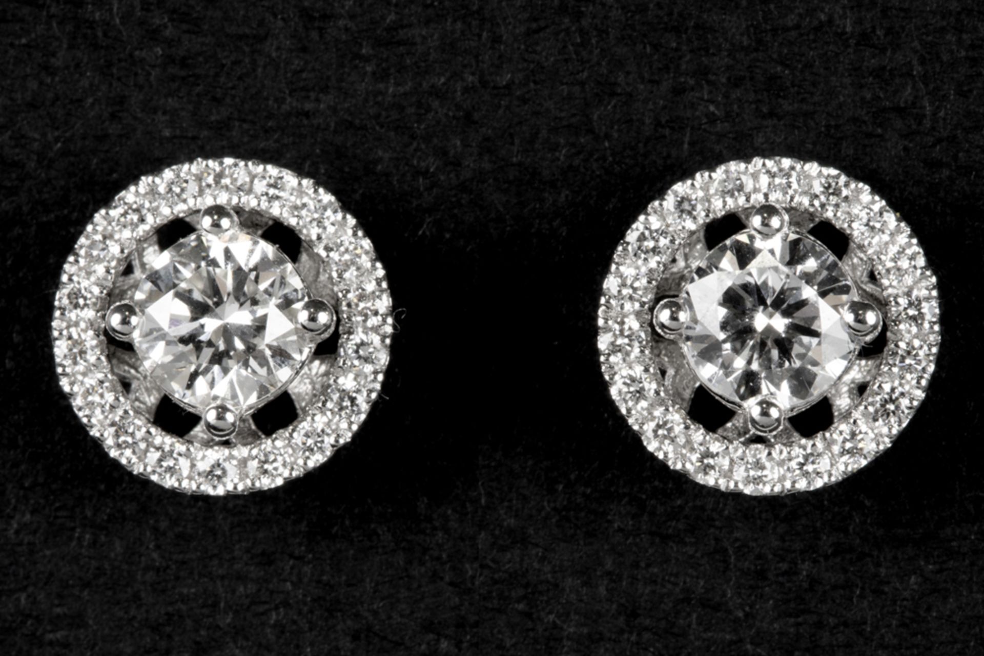 pair of earrings in white gold (18 carat) each with a bigger diamond surrounded by small ones - in