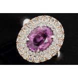 nice ring in white and pink gold (18 carat) with a 2,50 carat pink sapphire surrounded by 0,80 carat